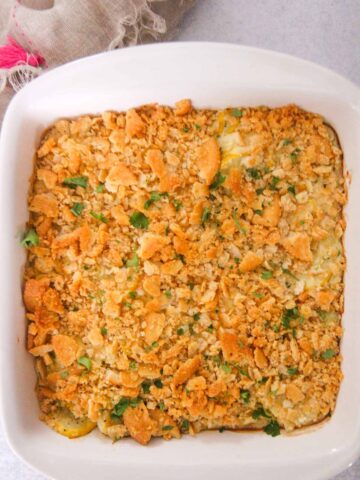 Southern yellow squash casserole in a white baking dish.