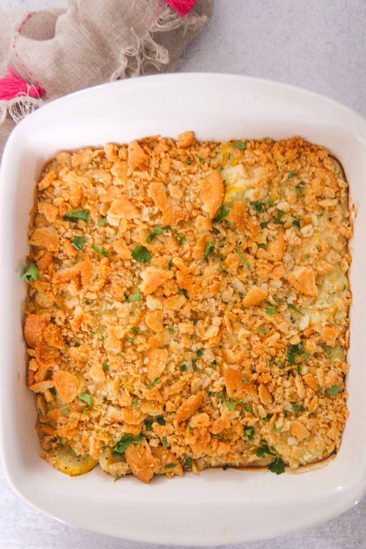 Southern yellow squash casserole in a white dish. 