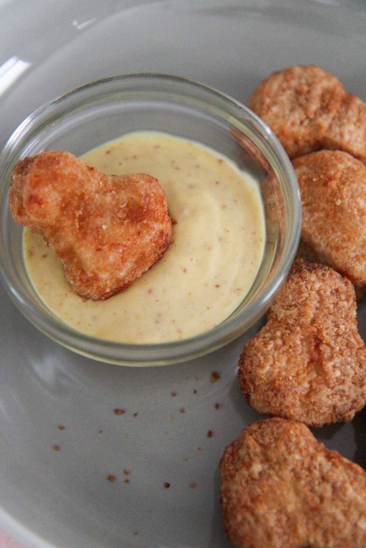 air fryer chicken nuggets with a side of honey mustard sauce. 