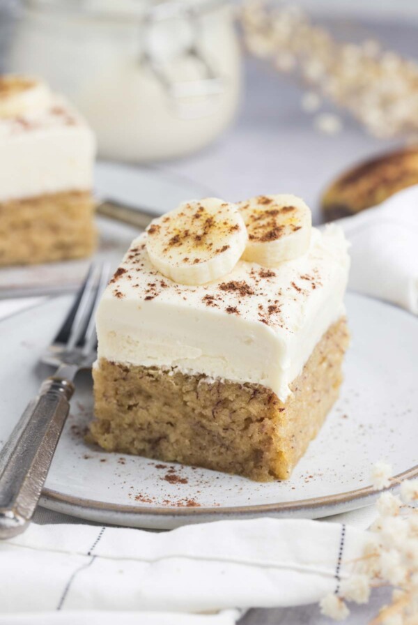 a slice of moist banana cake with a fork on the side.