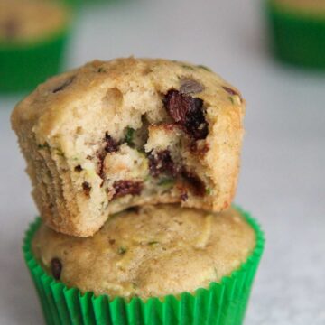 two zucchini chocolate chip muffins stacked