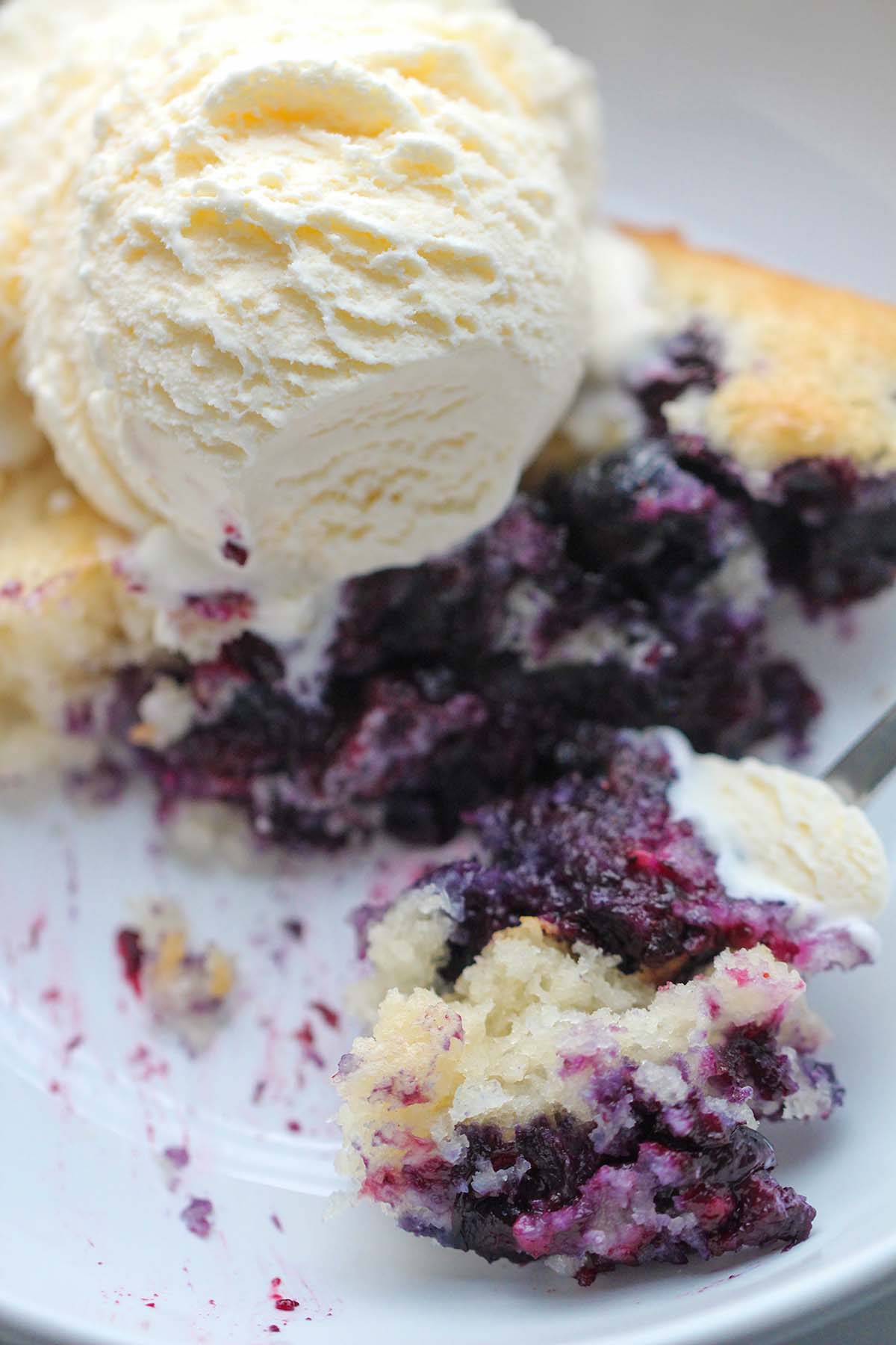 blueberry cobbler with a scoop of vanilla ice cream on top. 