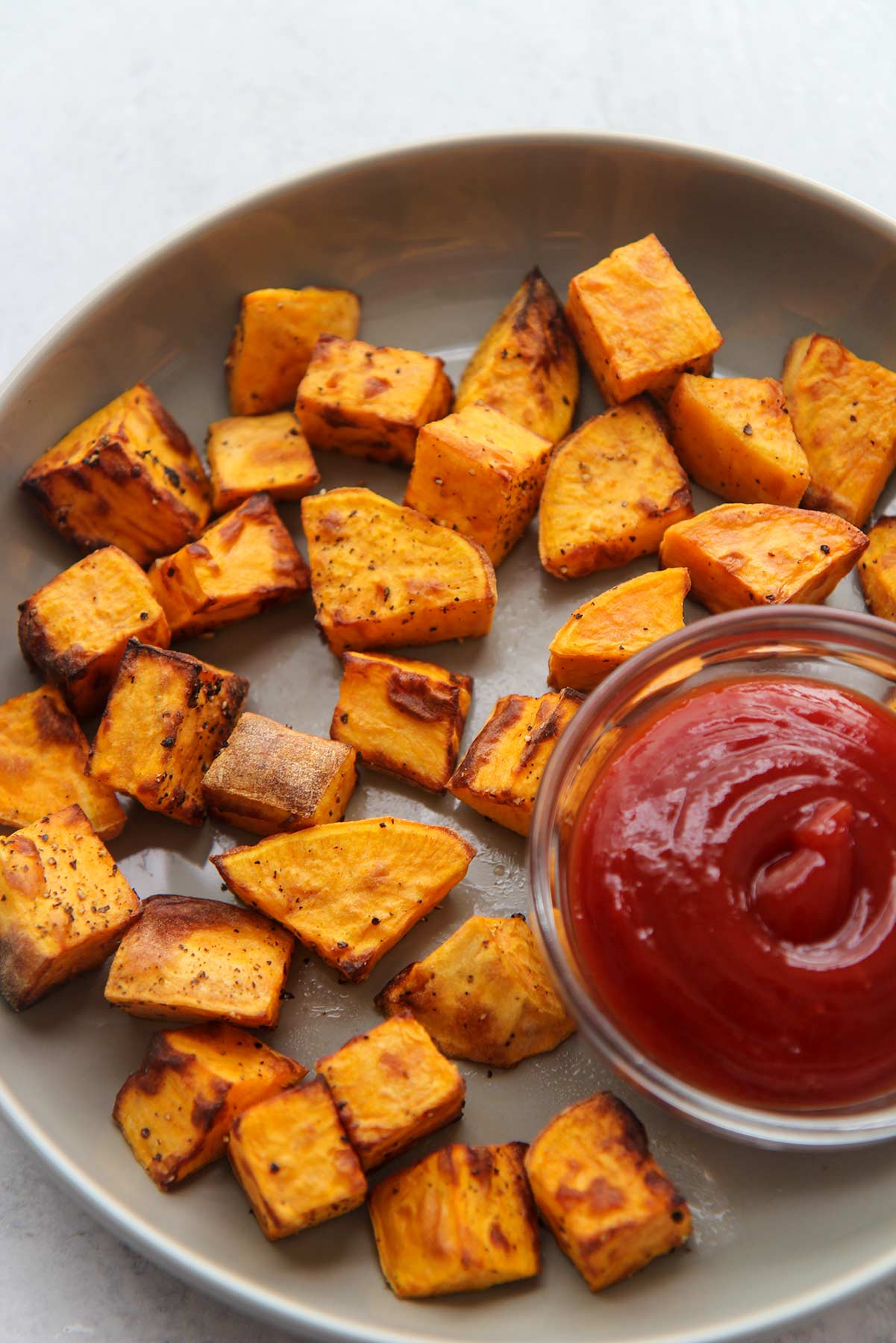 air fryer sweet potato cubes with ketchup on the side. 