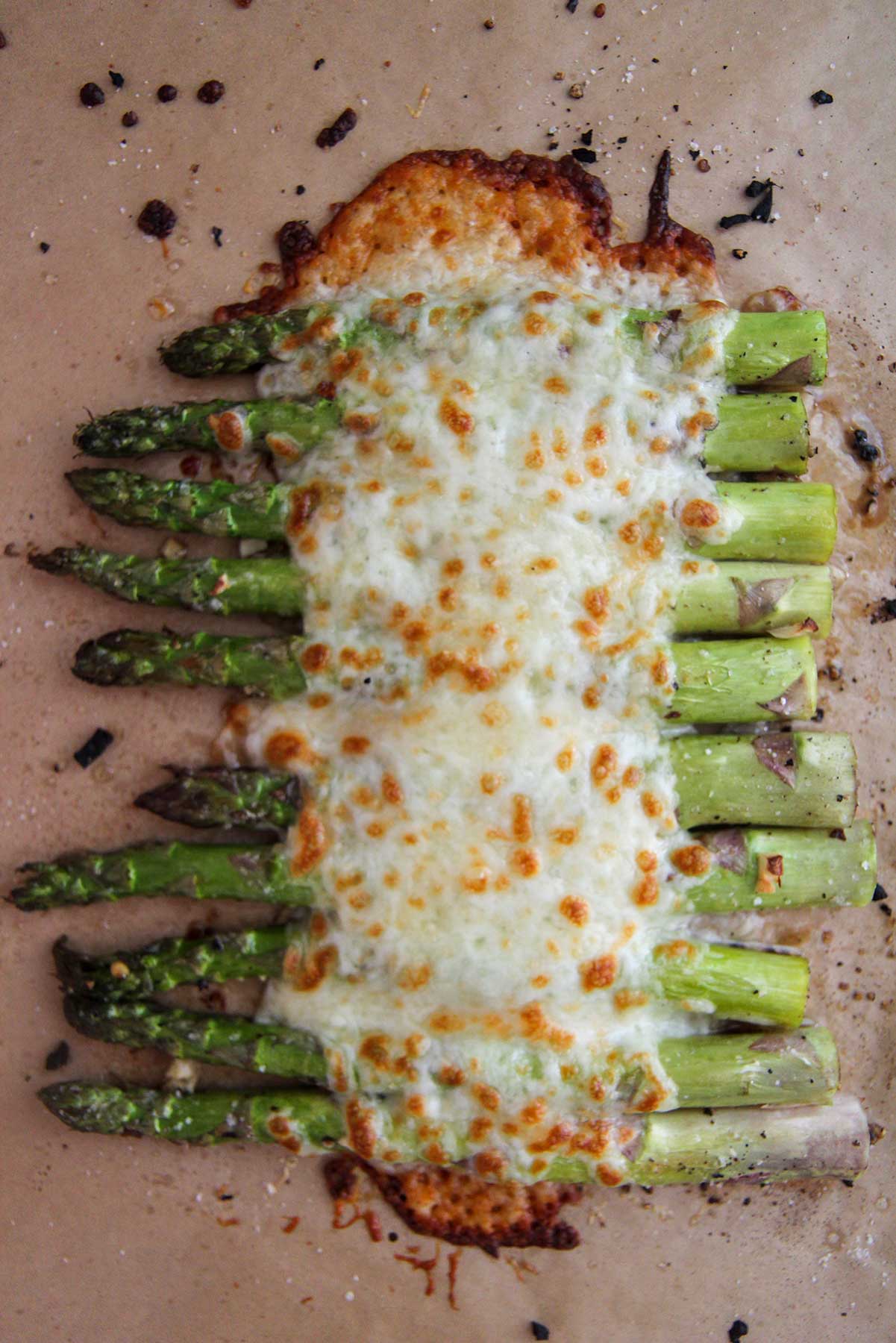 cheesy garlic asparagus on a baking sheet. 