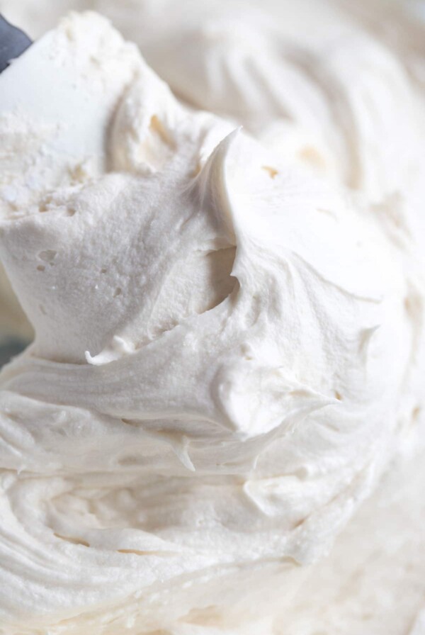cream cheese frosting with a rubber spatula up close.