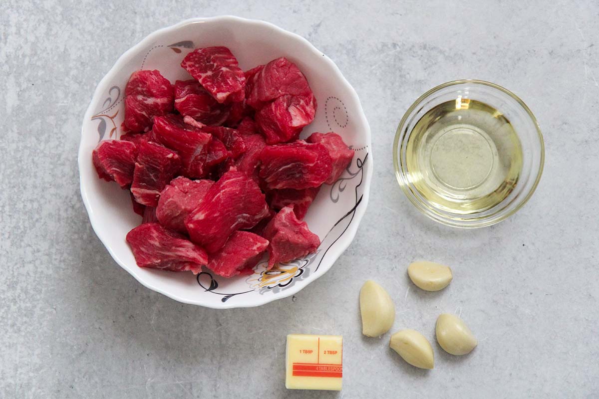 raw beef, four garlic cloves, butter, and oil. 