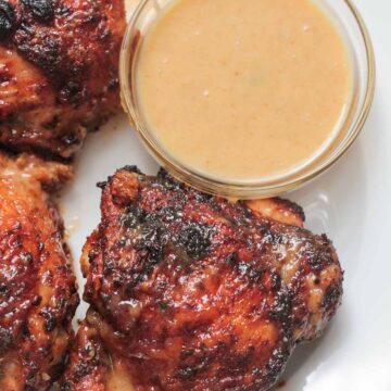 air fryer chicken thighs with a side of honey mustard.