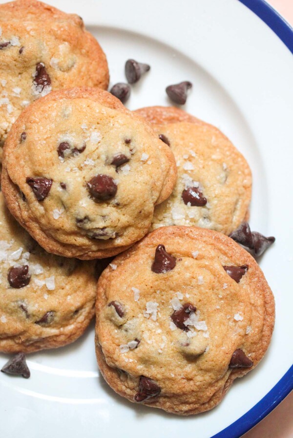 five brown butter chocolate chip cookies on a plate.