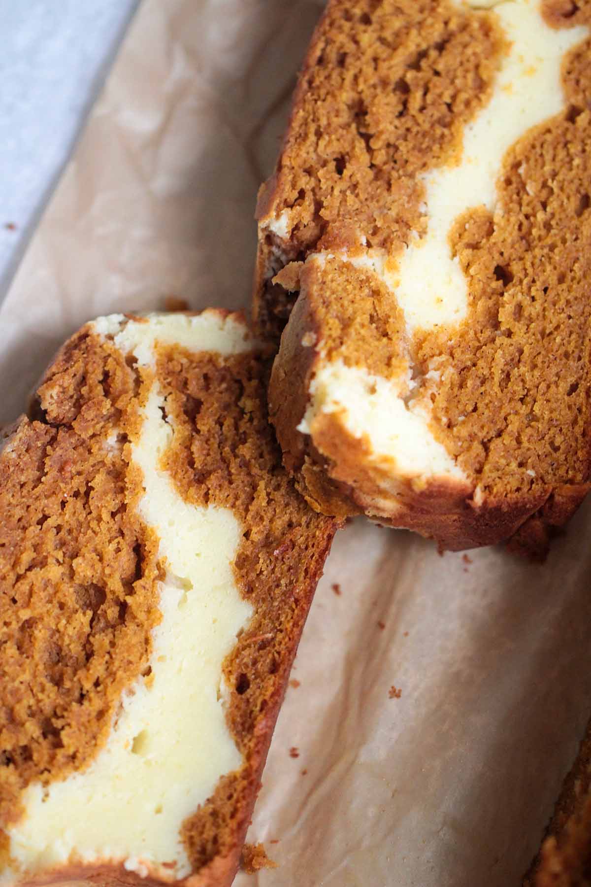 two slices of cream cheese pumpkin bread.