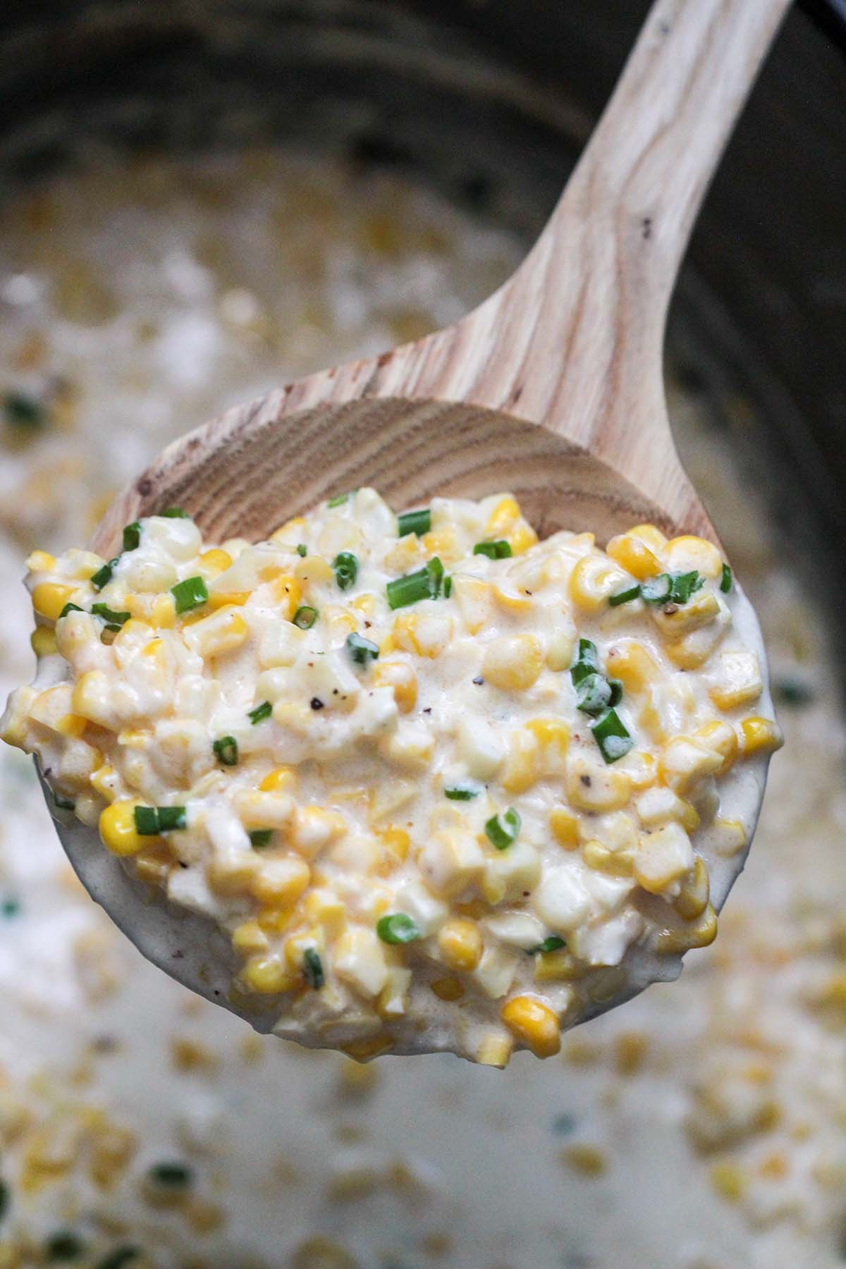 a spoon full of creamed corn.