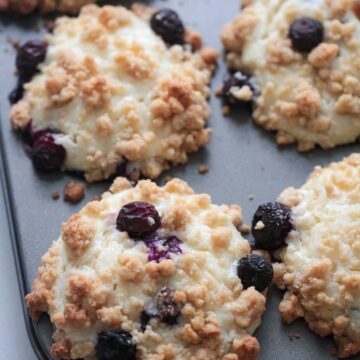 baked blueberry cream cheese muffins in a muffin tin.