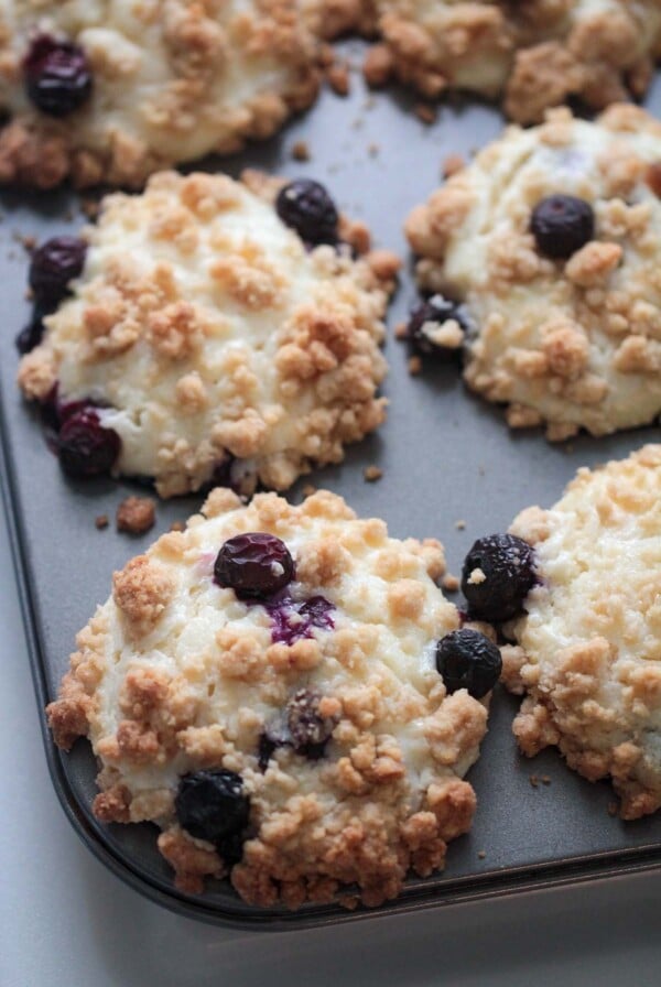 baked blueberry cream cheese muffins in a muffin tin.