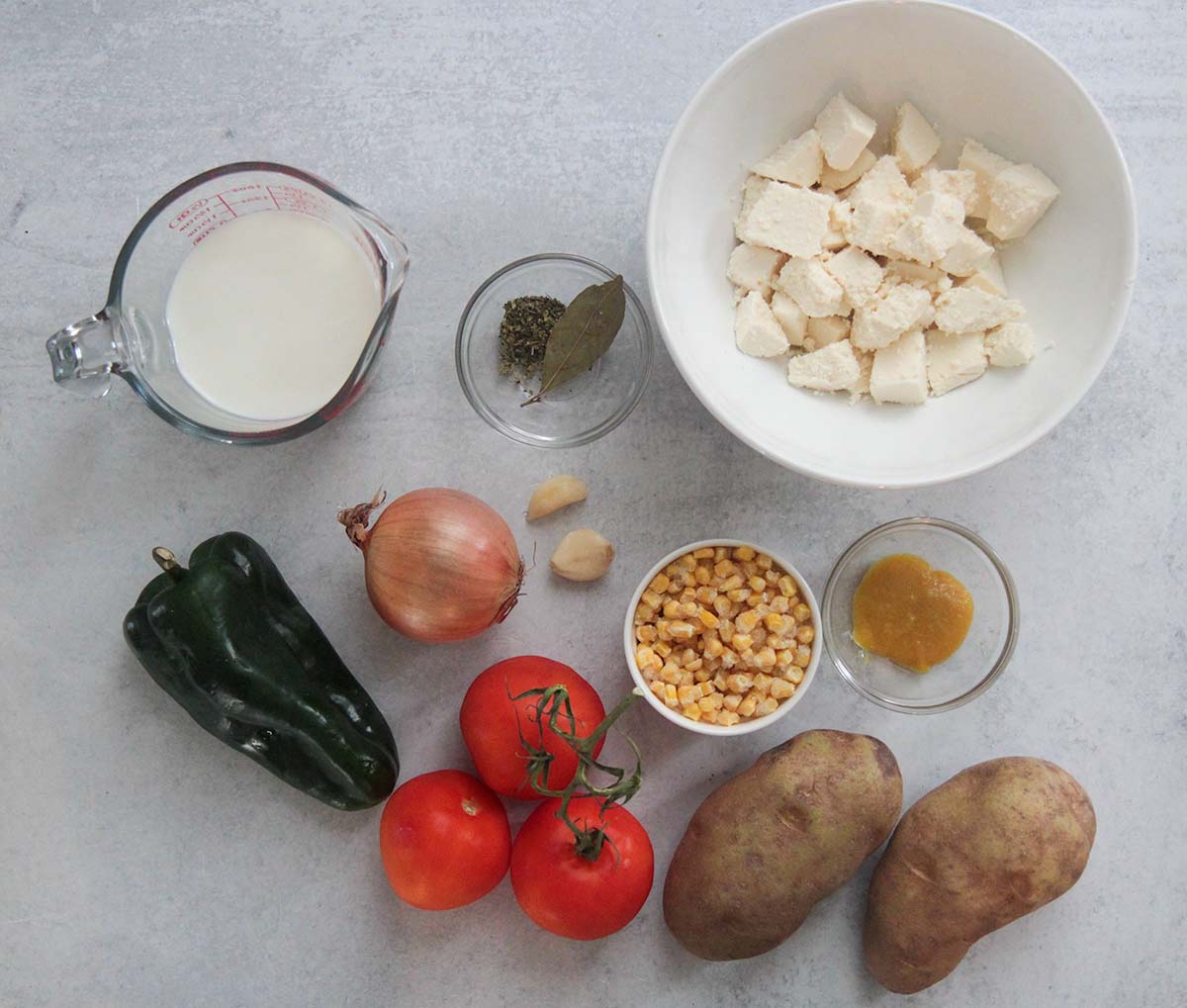 ingredients, potatoes, tomatoes, onion, garlic, pepper, chicken bouillon paste, cheese, milk, spices, corn. 