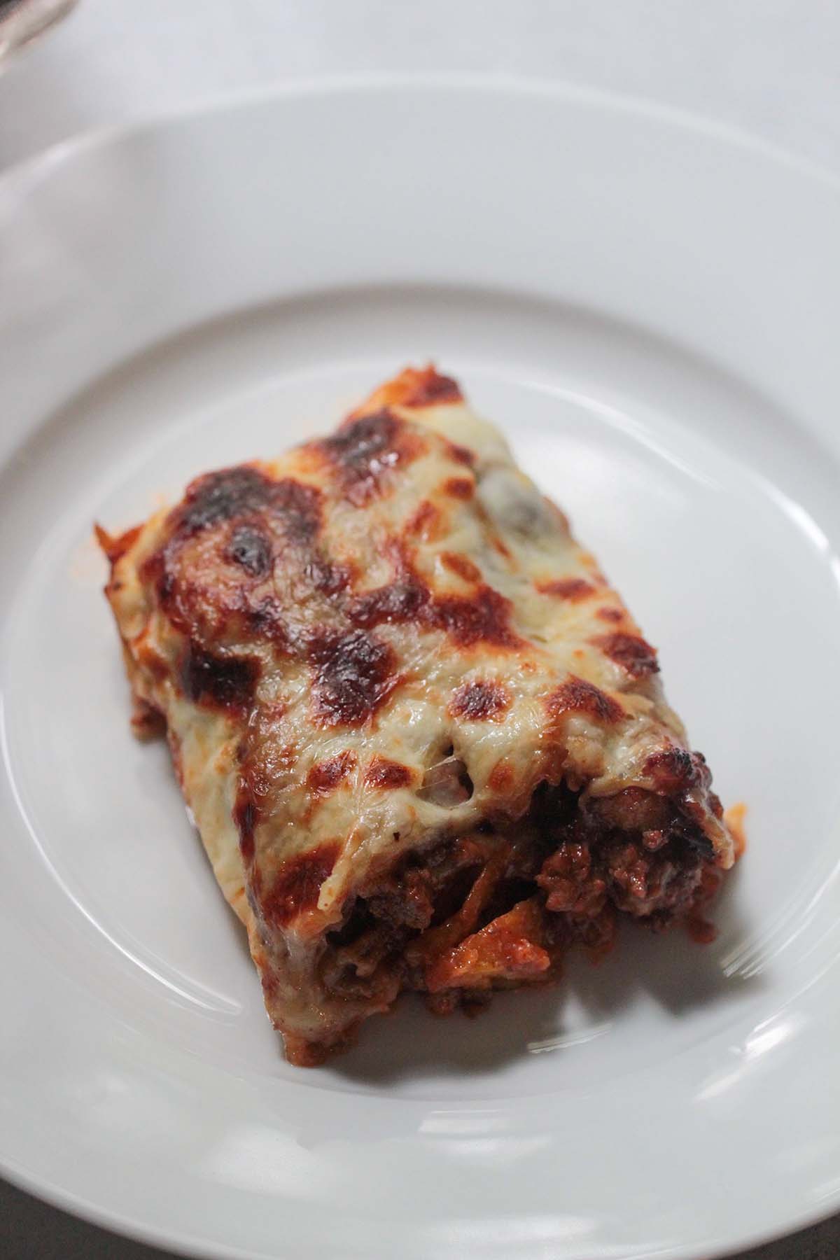a slice of pastelon on a white plate. 