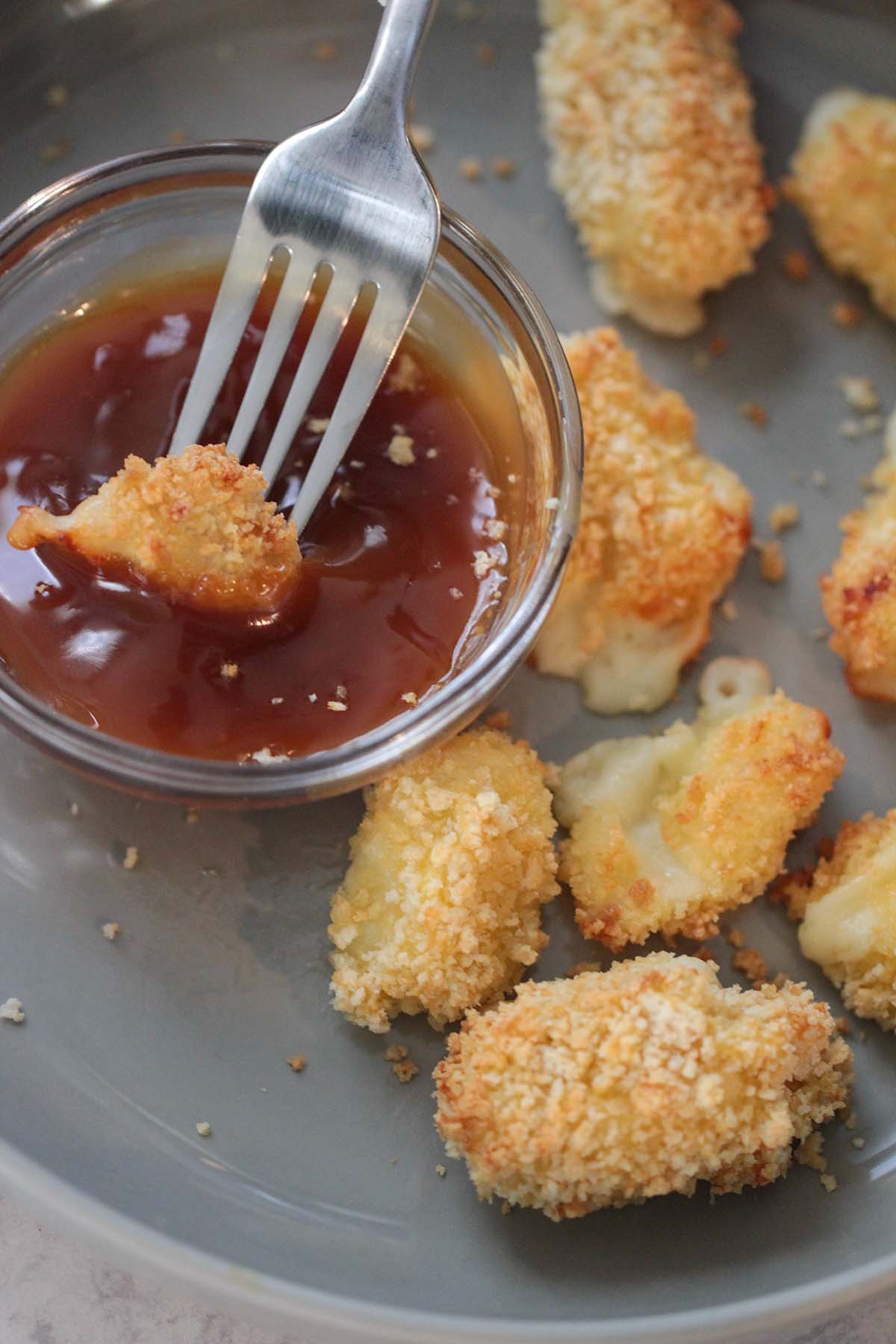 air fried cheese curds on a plate and a cheese curd dipped in caramel sauce. 