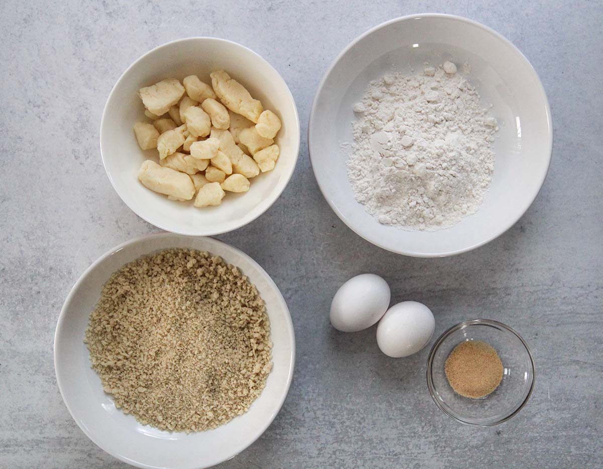 Ingredients, flour, cheese curds, eggs, garlic powder, and bread crumbs. 