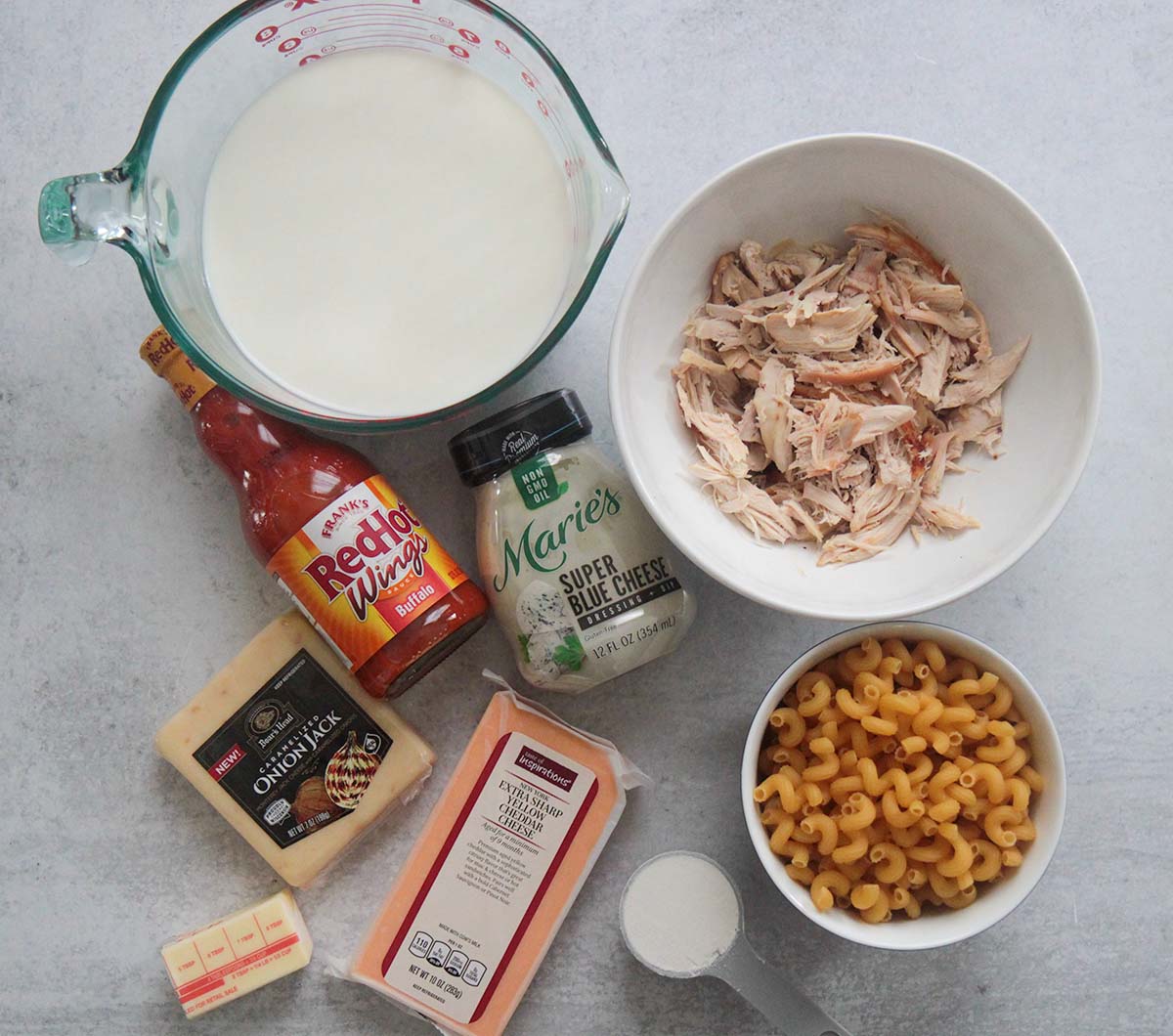 ingredients for buffalo chicken mac and cheese, pasta, cheese, flour, butter, milk, shredded chicken, buffalo sauce, blue cheese dressing, 