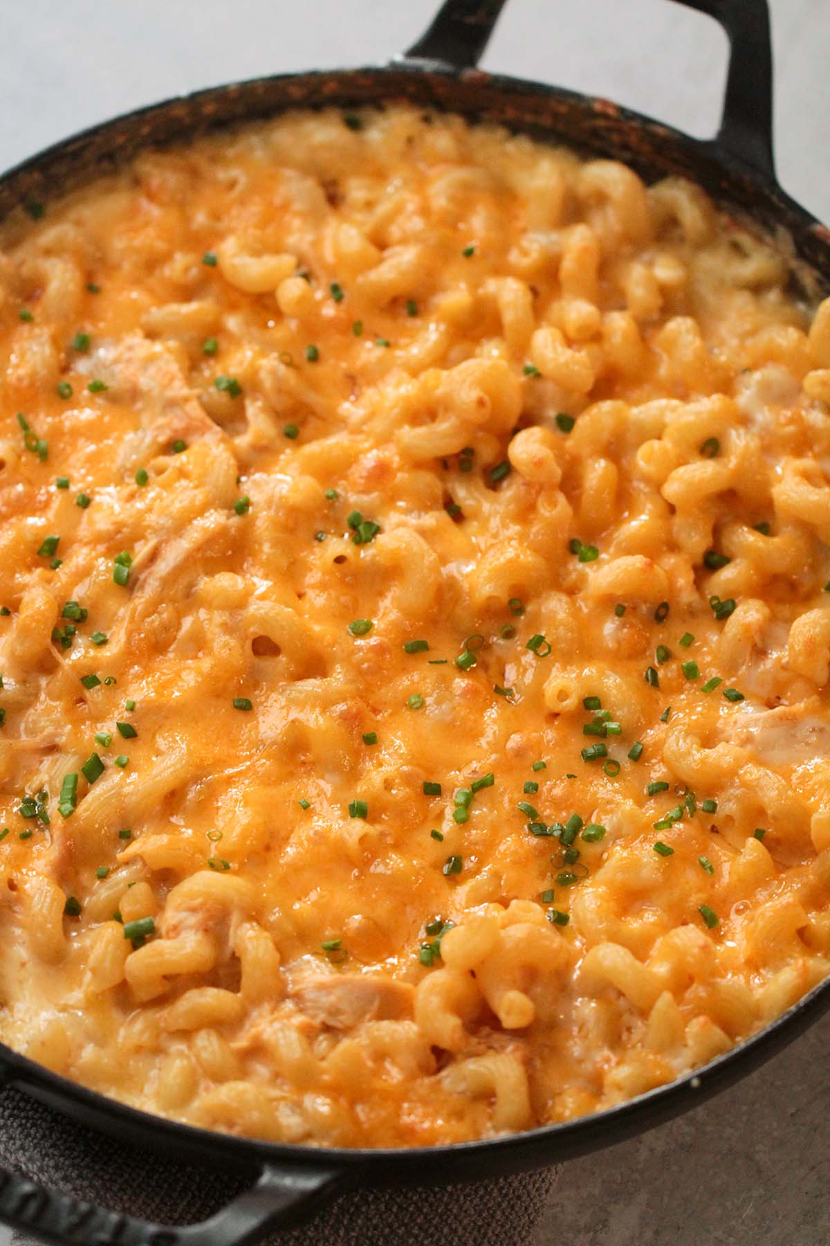 buffalo chicken mac and cheese with green chives on top. 