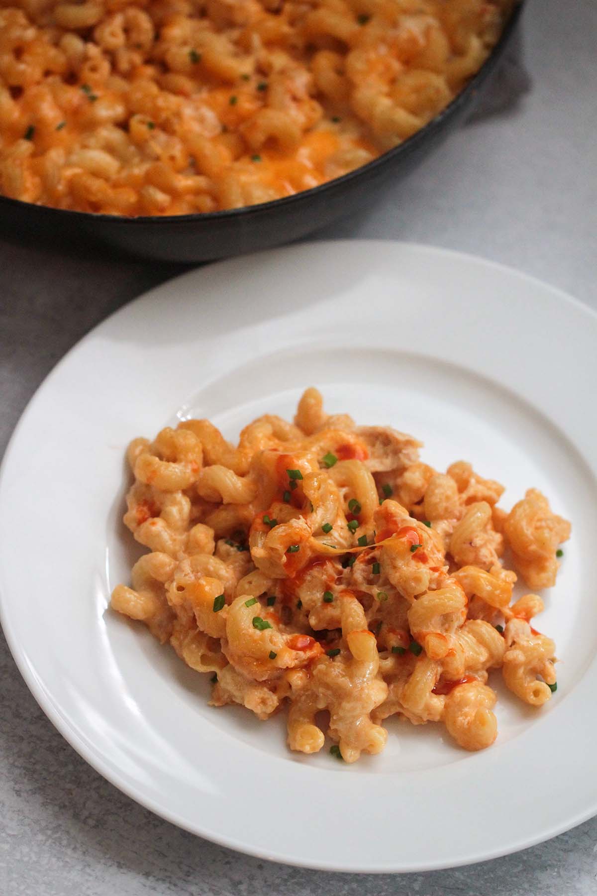 buffalo chicken mac and cheese on a white plate. 