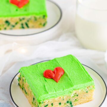 Grinch sugar cookie bar with green frosting and a red heart.