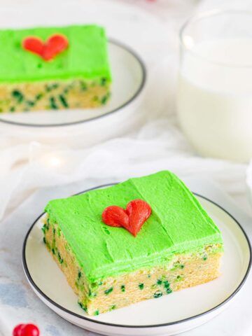Grinch sugar cookie bar with green frosting and a red heart.
