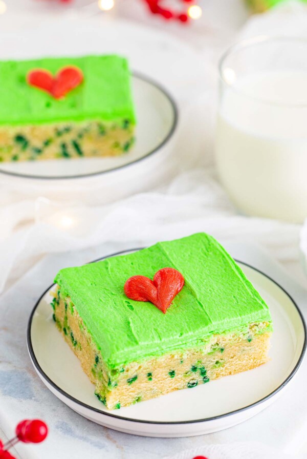 Grinch sugar cookie bar with green frosting and a red heart.