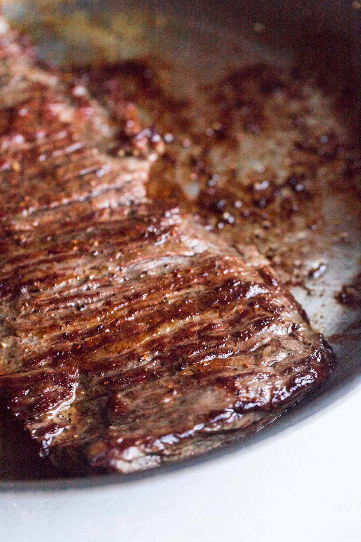 cooked skirt steak in a skillet. 