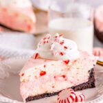 A slice of no-bake peppermint cheesecake on a white plate.