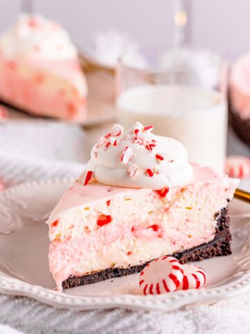 A slice of no-bake peppermint cheesecake on a white plate.