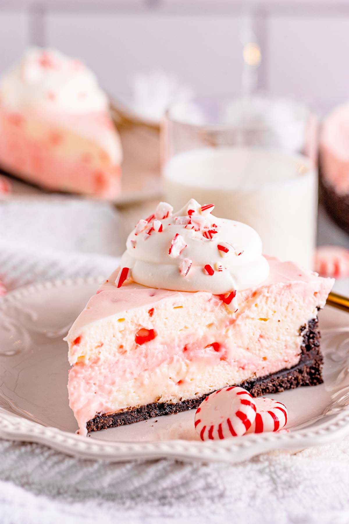 A slice of no-bake peppermint cheesecake on a white plate. 