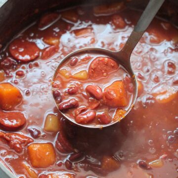 Cuban red beans in a large pot with a ladle.