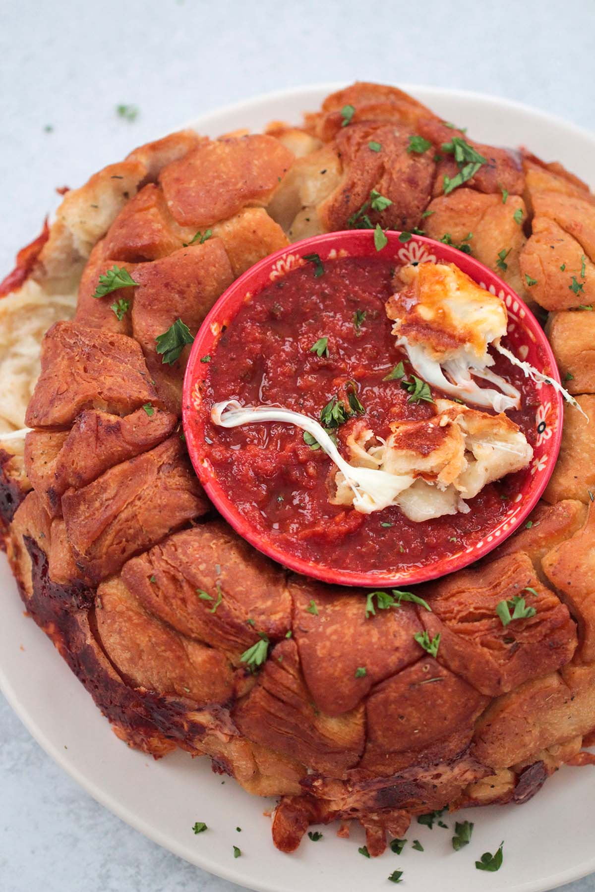pizza monkey bread with marinara sauce in a bowl. 