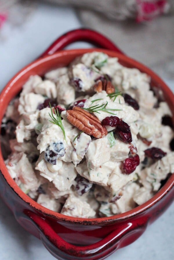 cranberry pecan chicken salad in a red bowl.