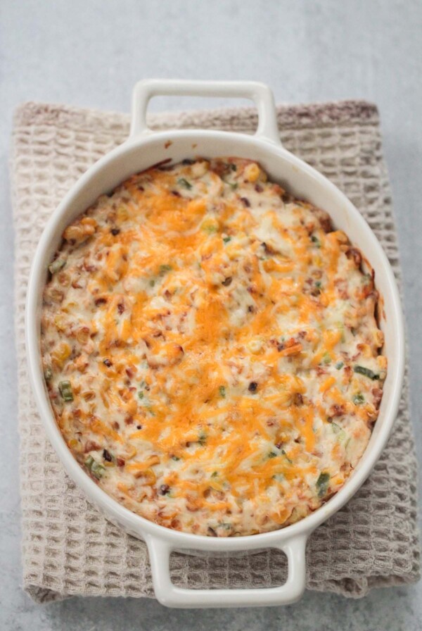 hot cheesy corn dip in a white dish.