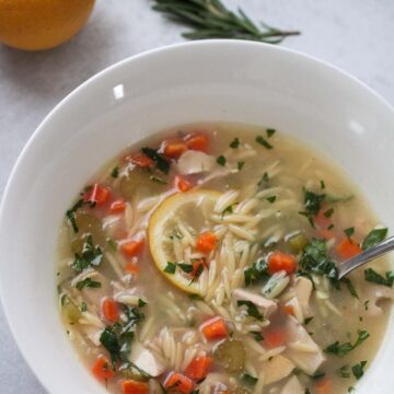 A bowl of lemon chicken orzo soup.