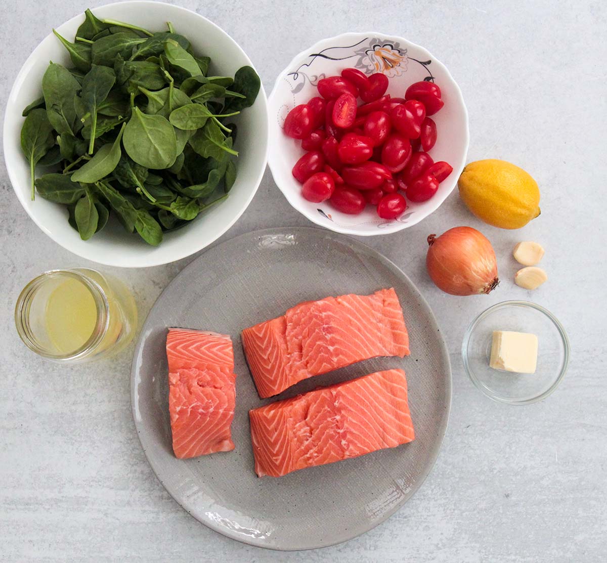 ingredients for salmon with tomatoes and spinach. 