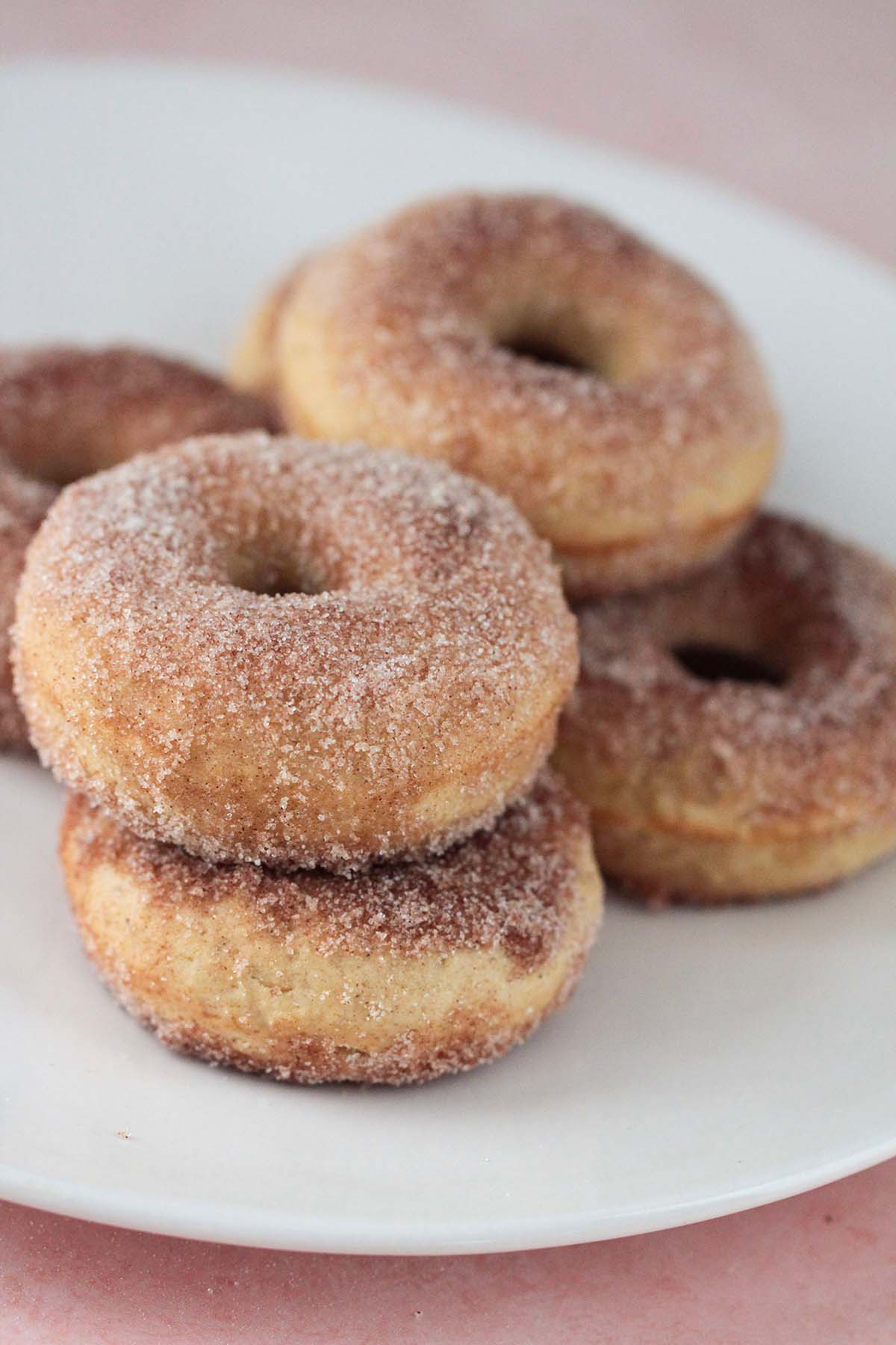 cinnamon sugar donuts on a white plate. 