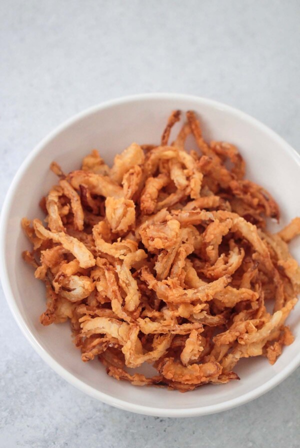 French fried onions in a white bowl.