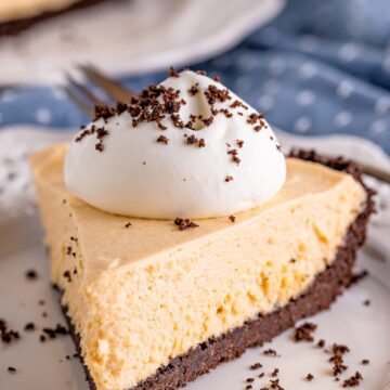 a slice of no-bake peanut butter pie with whipped cream on top.