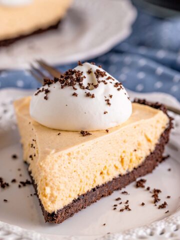 a slice of no-bake peanut butter pie with whipped cream on top.