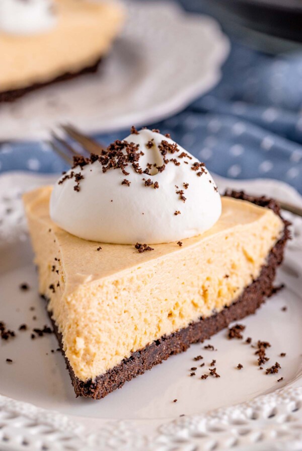a slice of no-bake peanut butter pie with whipped cream on top.