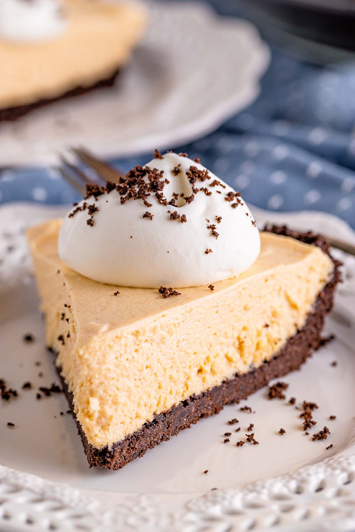 a slice of no-bake peanut butter pie with whipped cream on top. 