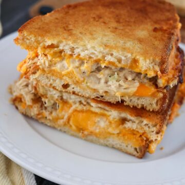 air fryer tuna melt sandwiches on a white plate.