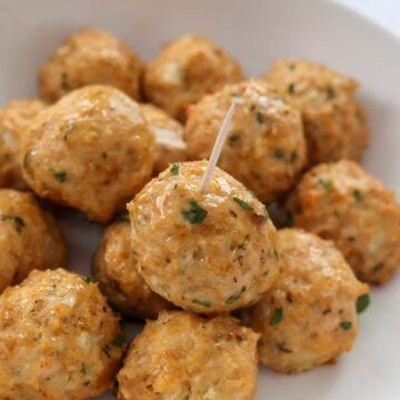 baked chicken meatballs on a white plate.