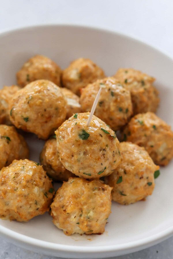 baked chicken meatballs on a white plate.