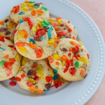 fruity pebbles cookies on a white plate.