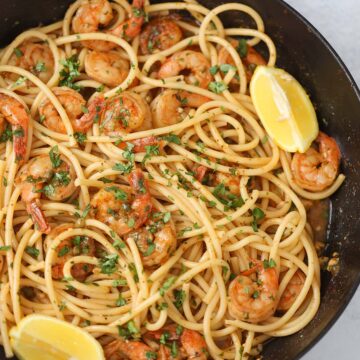 Cajun shrimp scampi with pasta in a skillet.