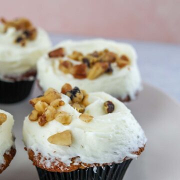 frosted carrot cake cupcakes with walnuts.