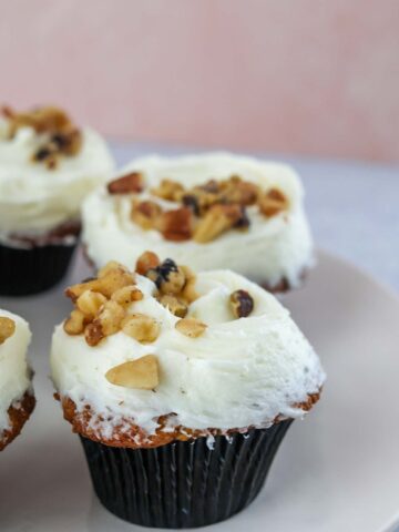 frosted carrot cake cupcakes with walnuts.