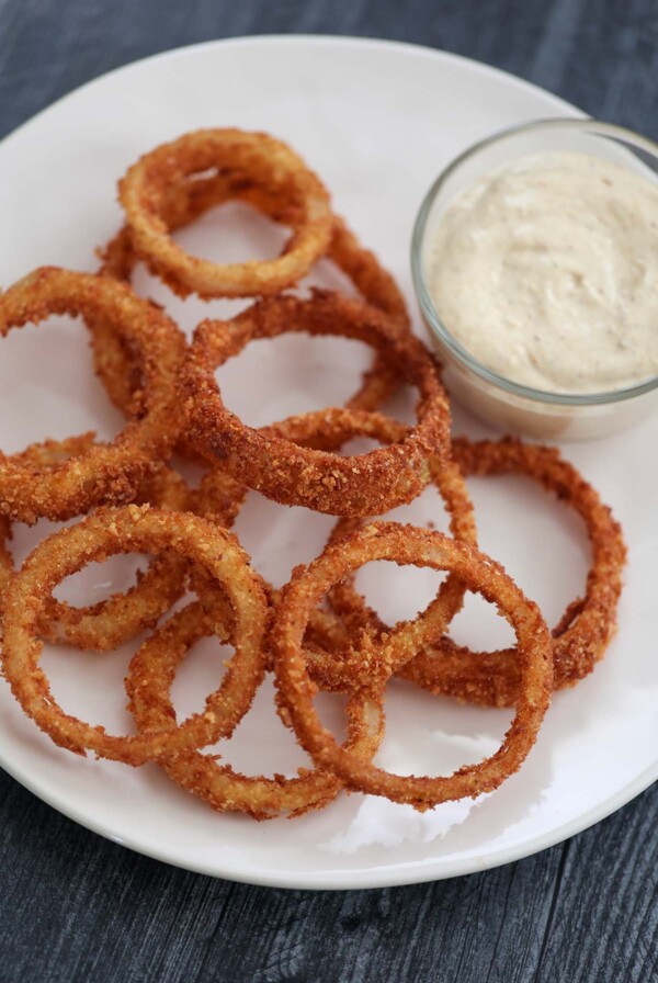 Crispy onion rings with spicy aioli on the side.